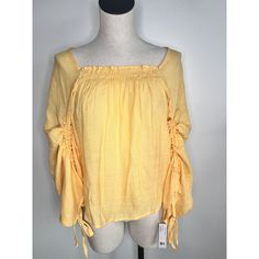 Zac & Rachel Peasant Tunic Top Size: Medium Color: Yellow (Tag Color: Flax) Condition: Nwt, New Features: Square Neck With Stretch, Cinched Sleeve, Tie Sleeve, Sheer, Flowy, Boho, Peasant Material: 65% Rayon 35% Polyester Measurements Are Shown Inside Photos Smoke Free Home I Ship Same Or Next Day, With The Exclusion Of Holidays With No Mail Delivery Fall Vacation Blouse With Smocked Back, Spring Vacation Tops With Drawstring Tie, Spring Flowy Tops With Smocked Back, Long Sleeve Drawstring Tops For Beach, Bohemian Spring Tops With Tassel Ties, Bohemian Tops With Tassel Ties For Spring, Fall Vacation Blouse With Smocked Bodice, Spring Long Sleeve Blouse With Drawstring, Summer Cotton Tops With Drawstring