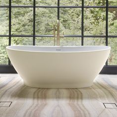 a white bath tub sitting in front of a window