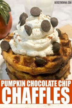 pumpkin chocolate chip waffles with whipped cream and chocolate chips on top, sitting on a white plate