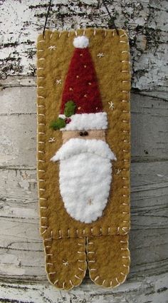 a santa clause ornament hanging on a wooden wall