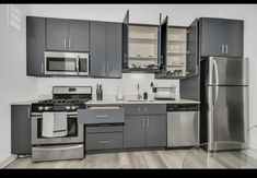 a kitchen with stainless steel appliances and cabinets