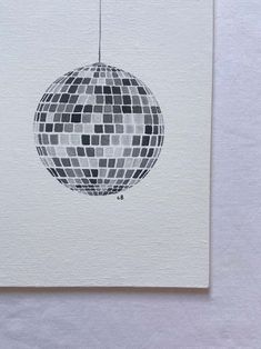 a white card with a black and white image of a disco ball hanging from a string