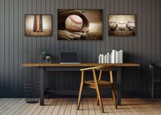 a desk with a laptop on it in front of two baseballs hanging above the table