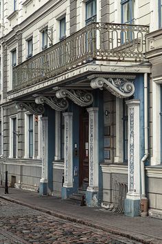 an old building with balcony and balconies on the second floor is painted blue