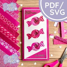 some pink paper and scissors on a table with other crafting supplies for valentine's day