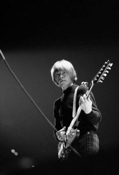 an image of a man playing guitar on stage