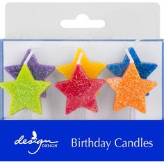 three birthday candles with glitter stars in the shape of stars on each one and two different colors