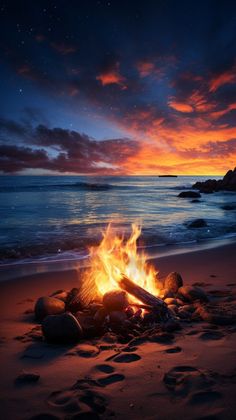 a campfire on the beach at sunset