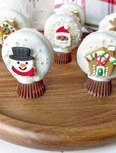 some cupcakes with frosting on them are decorated like christmas trees and snowmen