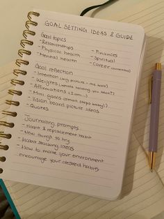 a spiral notebook with goal setting ideas and guide