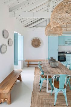 an instagramted photo of a dining room and kitchen with blue chairs in it