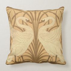 a decorative pillow with two swans on it