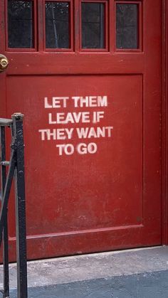 a red door with the words let them leave if they want to go