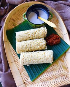 rice rolls and dipping sauce on a bamboo tray