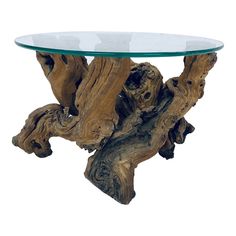 a glass and wood table sitting on top of a white floor