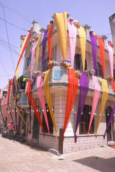 colorful streamers hanging from the side of a building