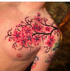 a woman's chest with pink flowers on it and black outline around the breast