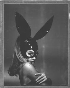 a woman wearing a bunny mask in black and white