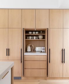 a kitchen with wooden cabinets and white counter tops