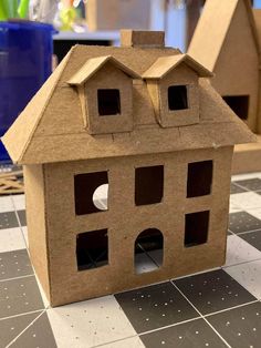 a cardboard house sitting on top of a table