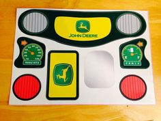 the john deere sticker sheet is on top of a wooden table with various gauges