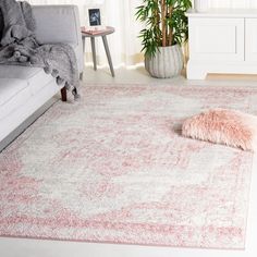 a living room with a couch and rug on the floor