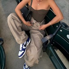 a woman sitting on top of a green bench