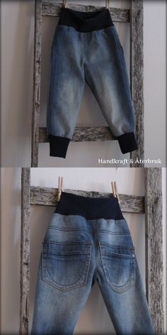 two pairs of jeans are hanging on a ladder