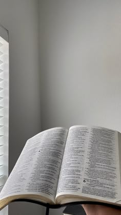 an open book sitting on top of a chair