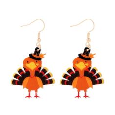 a pair of earrings with a turkey wearing a hat