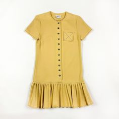 -SO SO GOOD!  -1960s Jonathan Logan pale yellow drop waist mini dress  -major mod vibes  -small pocket with X detail  -no flaws to note  -would best fit a size small, fabric has a little give to it  -heavy weight polyester  -buttons down the front  -black contrast stitching  MEASUREMENTS shoulders: 14.5 inches from seam to seam  armpit to armpit: 18.5 inches flat  waist: 17 inches flat  hips: 19.5 inches flat  length: 35 inches armpit to bottom of sleeve: 1.5 inches 60s Drop Waist Dress, Vintage Ruffled Mini Dress For Fall, Vintage Mini Dress With Ruffle Hem, Yellow Short Sleeve Vintage Mini Dress, Mod Clothing, Jonathan Logan, Mod Scooter, 1970s Fashion, Double Knit