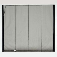 a white curtain with black trim hanging on the wall in front of a gray background