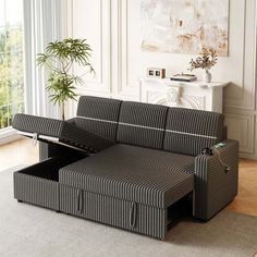 a black and white striped couch with an open storage compartment in the middle of it