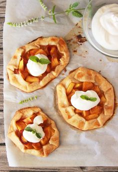 three small pies with whipped cream on top