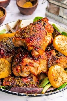 a plate filled with chicken and vegetables on top of a table next to other dishes