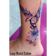 a tattoo on the foot of a woman with a bird flying over her head and wings