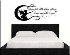 a wall decal with an image of a fairy sitting on the moon above a bed