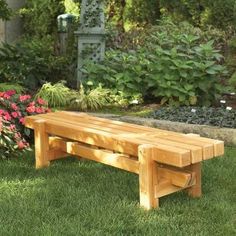 a wooden bench sitting on top of a lush green field