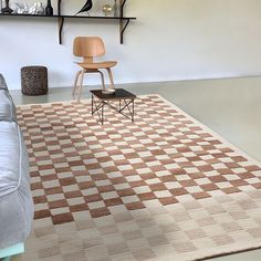 a living room with a checkered rug on the floor