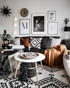 a black and white living room with pictures on the wall, coffee table and couch