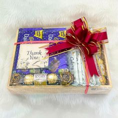 a gift box filled with chocolates and candy