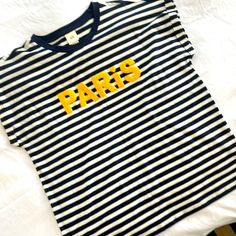 Navy Blue/White Stripe With Yellow “Paris”. No Tags But Never Worn Navy Tops With Letter Print For Spring, Sporty Spring Tops From H&m, Sporty Spring Tops By H&m, Sporty H&m Tops For Spring, H&m Spring Tops With Letter Print, H&m Spring Letter Print Tops, H&m Tops With Letter Print For Spring, Blue Crew Neck Tops By H&m, Blue Crew Neck Top From H&m