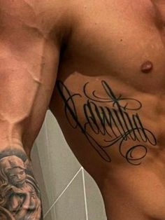 a shirtless man with tattoos on his chest and arm is taking a selfie in the mirror