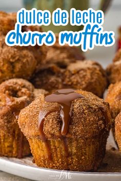 there are some muffins with chocolate drizzled on them and the words, dulce de leche churro muffins muffins