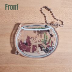 a glass case with an image of a horse and cactus inside it on a wooden surface