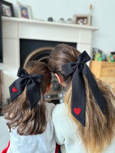 Make a statement this Valentine's Day with our exquisite hand-embroidered black long tail bow featuring a plush red heart. This sophisticated accessory, available in two sizes, brings a touch of romance and charm to any hairstyle. Whether you're looking to match with your little one or make a solo statement, these bows are the epitome of love in every detail. The crowning glory of these bows is the fluffy red heart embroidery, adding a playful and luxurious touch to the classic black background. Valentines Hair Bows, Mum And Daughter Matching, Valentine Hair Bows, Mum And Daughter, Valentine Hair, Diy Hair Accessories Ribbon, Mom And Daughter Matching, Bows Diy Ribbon, Hair Bow Sets