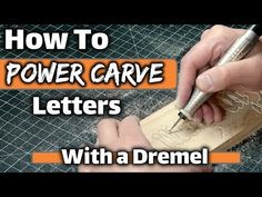 a person using a pen to write letters on a piece of wood with the words how to power carve letters with a dremel