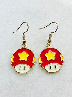 "Super Mario Brother- Super Mushroom Dangle Earrings: Transform your style with the Super Mushroom earrings, reminiscent of the power-up that makes Mario grow big and strong. These earrings feature the iconic red and white design, symbolizing newfound strength. Great addition for your school earrings collection or great to add to your costume for Halloween! Approximately 1\" long x 2mm in diameter wide Purrfectly Artistic specializes in crafting handmade fashion items, accessories, and thoughtful gifts. Just like every individual is unique, each of our products is crafted with its own distinctive charm, ensuring that no two pieces are exactly alike. Our creations are meticulously handcrafted with a touch of love, and we sincerely hope that you cherish your one-of-a-kind item as much as we Mario Bros Mushroom, Duo Outfits, Mario Brother, School Earrings, Mushroom Earrings, Costume For Halloween, Mario Bros., Mario And Luigi, Earrings Collection