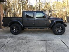 a black jeep parked in front of a brick building