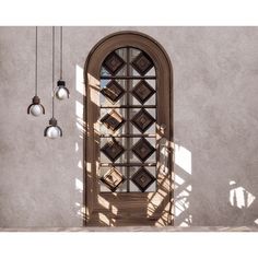 an arched window with three hanging lights in front of it and a shadow on the wall